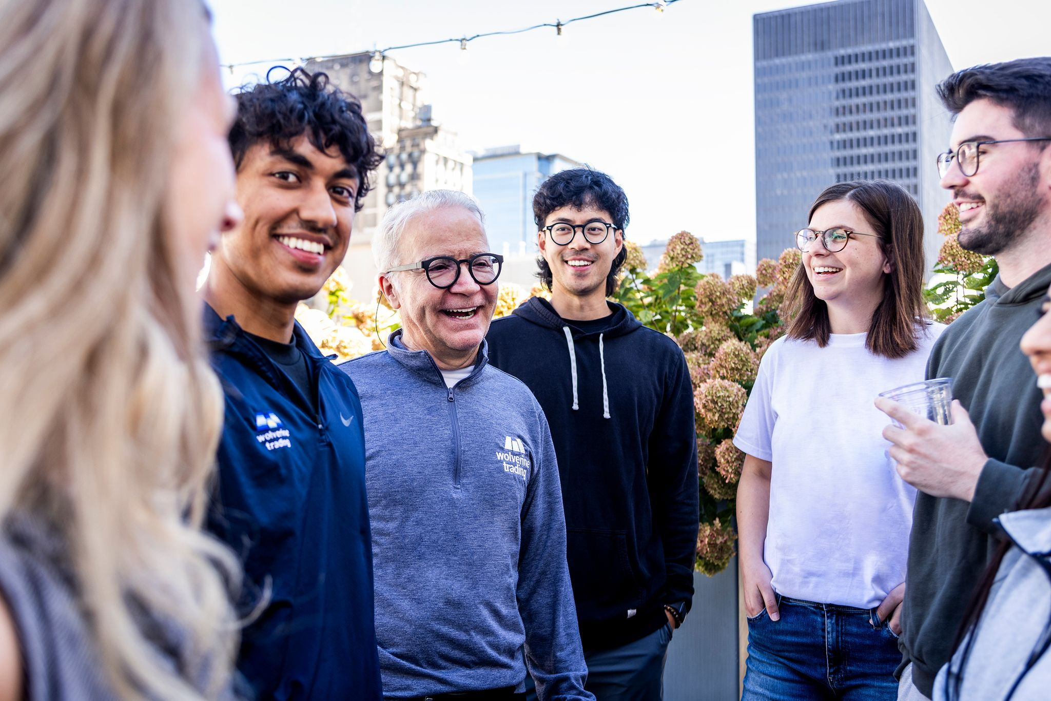 Wolverine team members laughing together on a rooftop terrace
